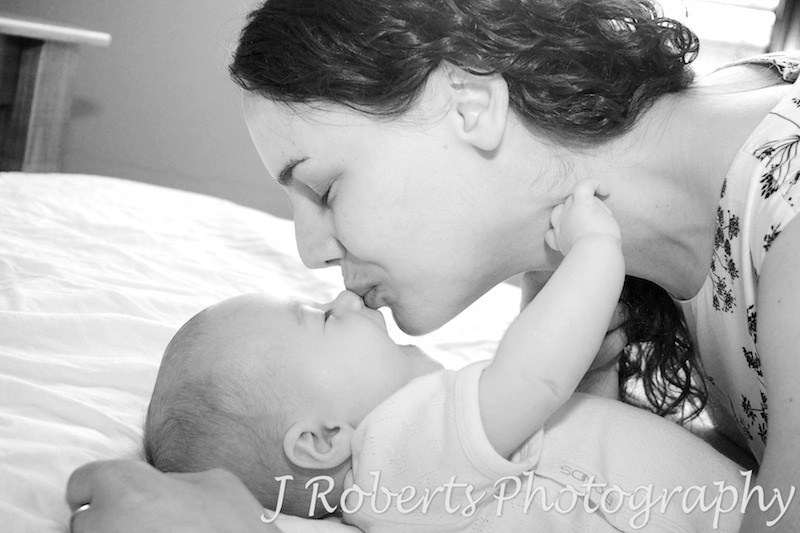 Mother kissing baby on the nose - baby portrait photography sydney